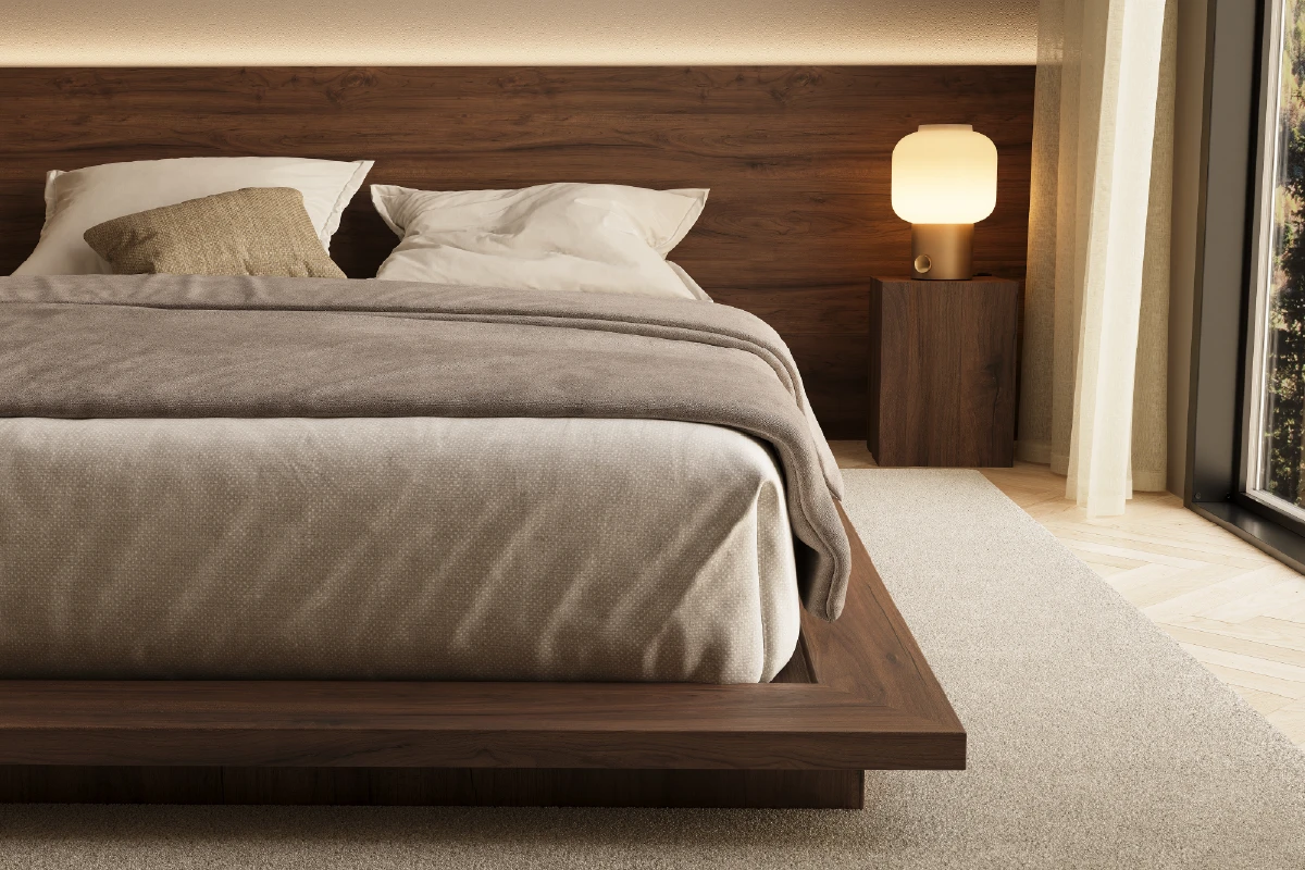 Detail van het lage houten bedframe in noten met zwevend effect