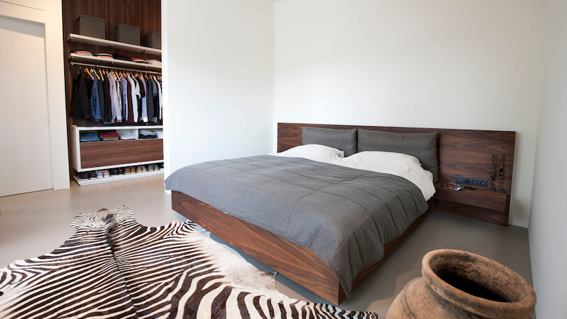 moderne, japanse en industriële slaapkamer met houten bed en inloopkast