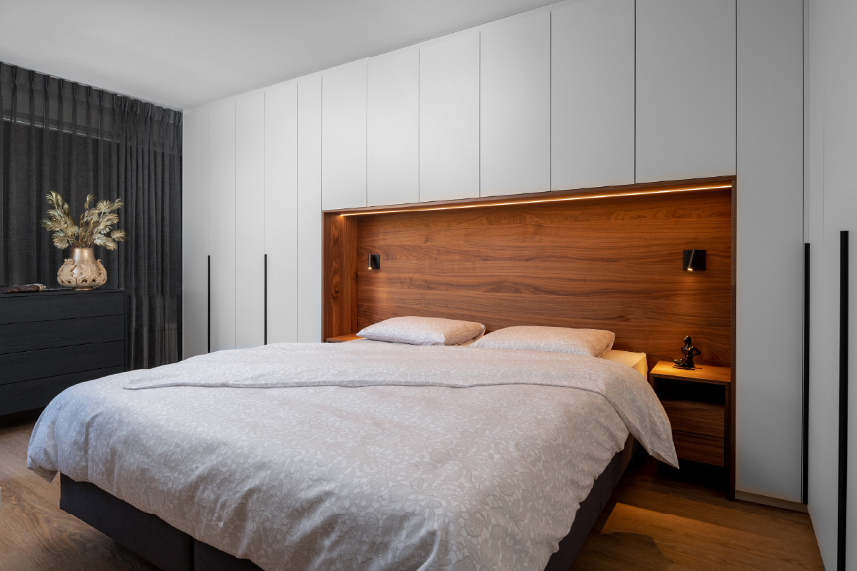 Slaapkamer met kastombouw en brugkast boven het bed