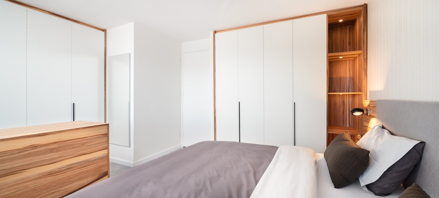 Overzicht van luxe slaapkamer met Red Gum-hout en maatwerk TV-meubel